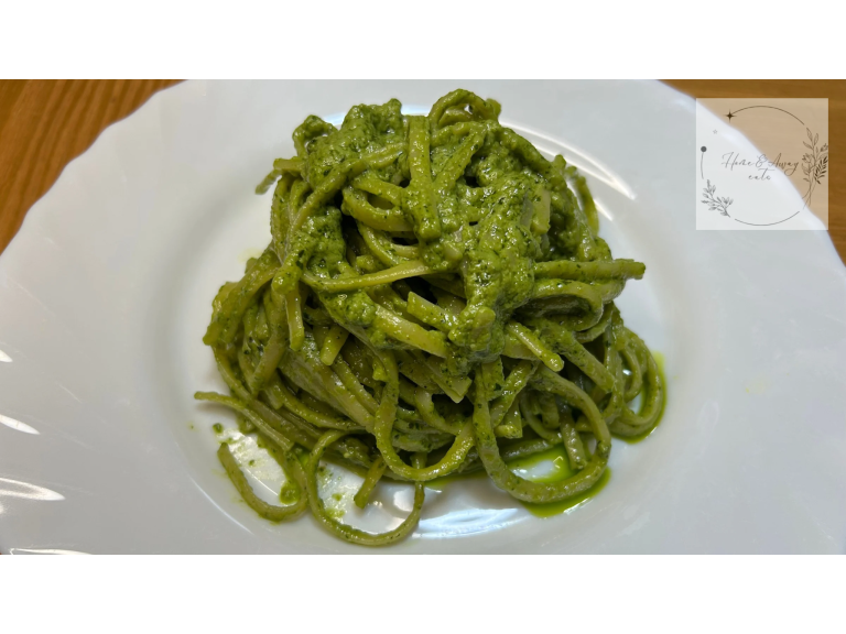 Italian pasta coated in fresh basil pesto.
