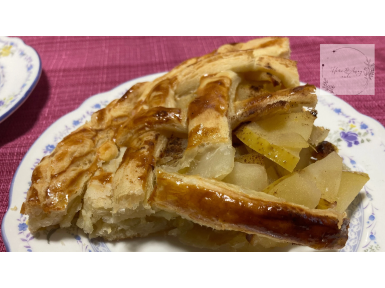 Golden-brown French apple pie with a flaky crust, served on a plate.