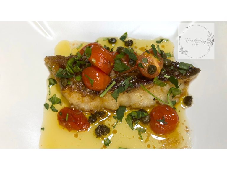 Golden crispy cod fillet served with anchovy sauce and garnished with capers and Italian parsley