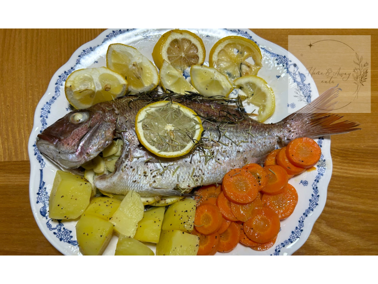 A whole baked sea bream with lemon slices and rosemary on a plate