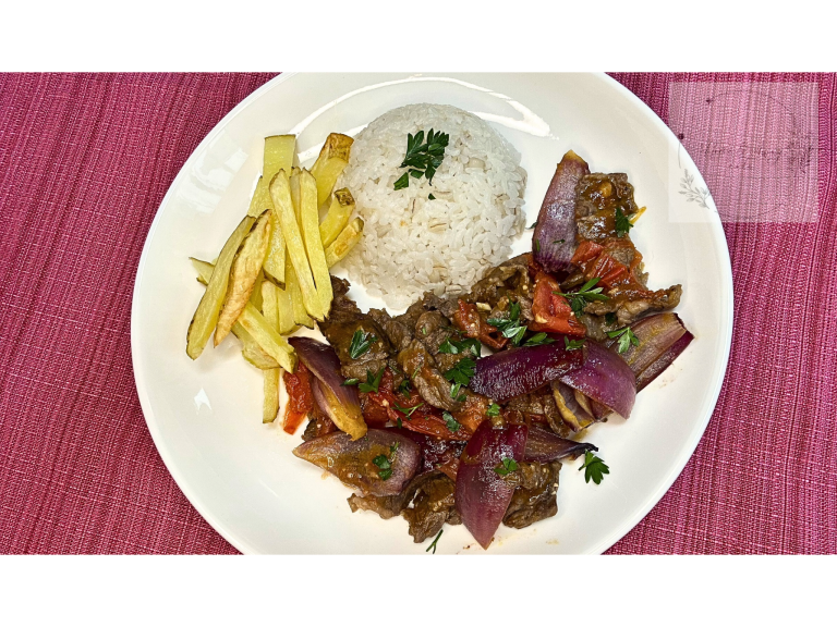 A plate of Lomo Saltado with juicy beef, crispy fries, and rice.