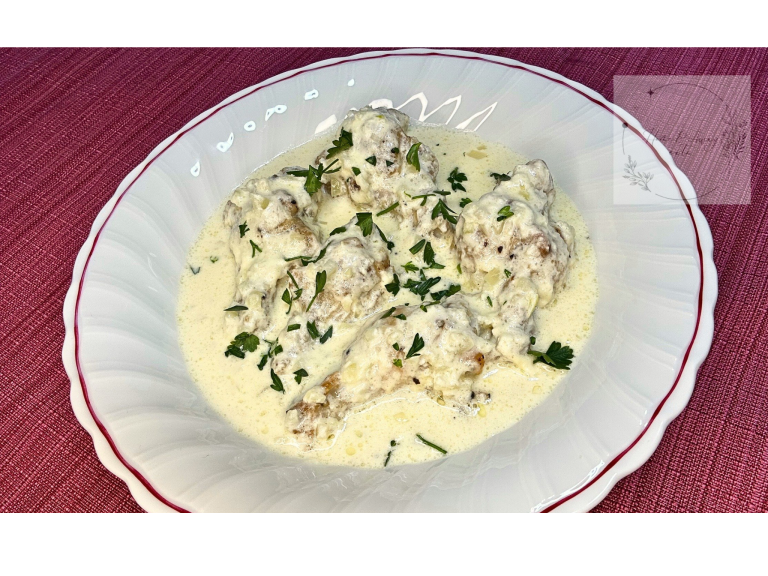 A bowl of Shkmeruli – Georgian creamy garlic chicken stew