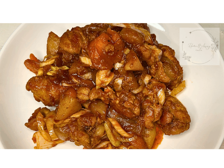 A plate of Dakdoritang with tender chicken, vegetables, and rich red broth