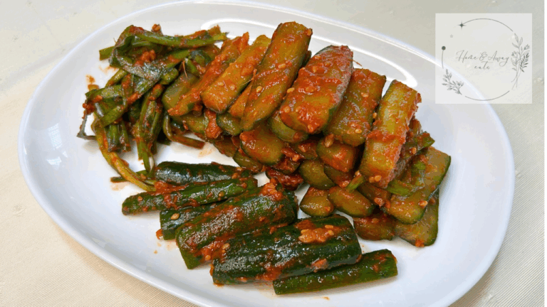 A bowl of homemade Oi Kimchi with vibrant red seasoning and chopped garlic chives