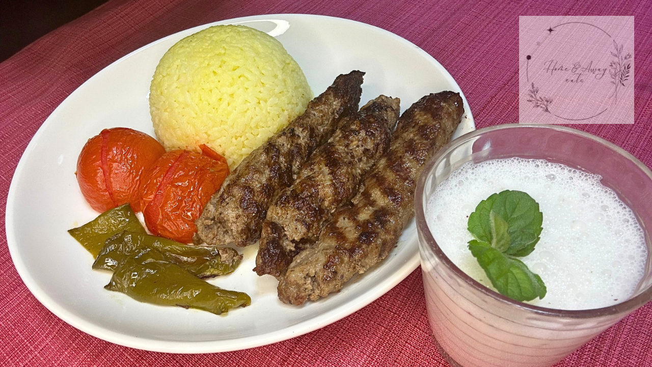 Close up of Persian Kabob Koobideh served with saffron rice and vegetables.