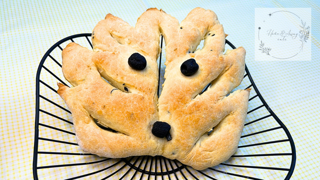 A freshly baked leaf-shaped fougasse with black olives