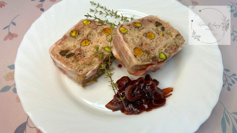 Sliced rustic French terrine with red wine onion sauce on a plate